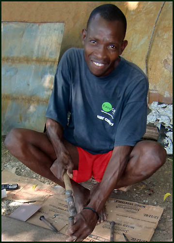  Cutting recycled steel drum in Haiti - Haitian metal tropical designs . - www.tropicdecor.com